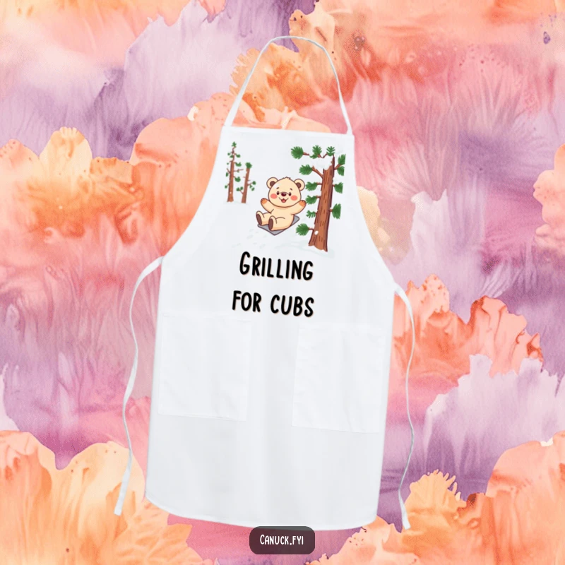 Funny bear cub apron showing a smiling cub gleefully sliding down a snow-covered pine tree while cooking.