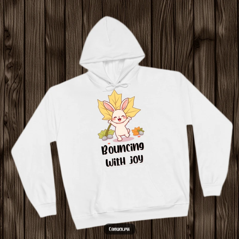 Funny rabbit hoodie depicting a bouncy rabbit character joyfully dancing near a large maple leaf.