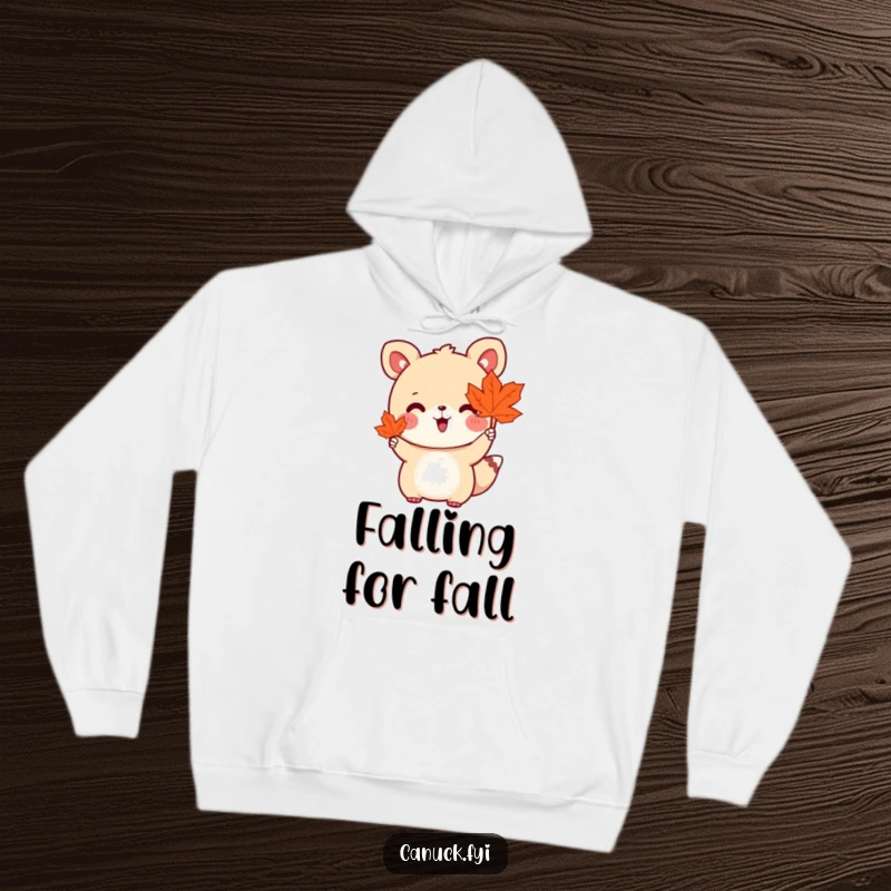Funny hoodie depicting a cute animal character holding a maple leaf and waving enthusiastically, offering warmth and seasonal charm.