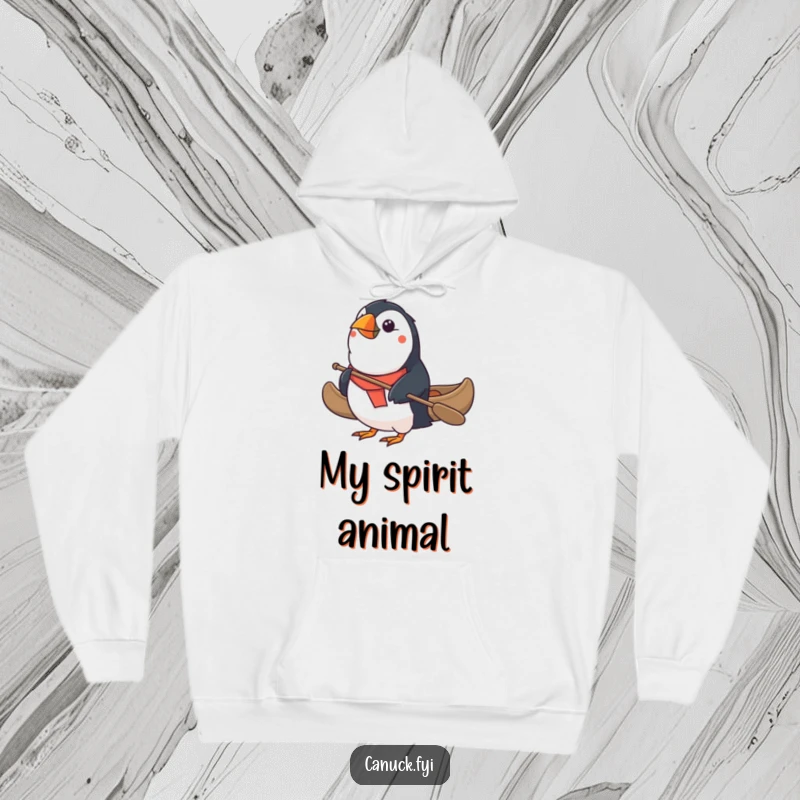 Funny Puffin Hoodie: A determined puffin navigates a small canoe, showcasing perseverance and a dash of absurdity. A great funny gift.